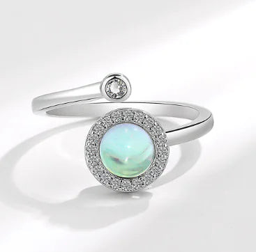 Chic Spin Ring for Fashion-Forward Women featuring a stunning opal surrounded by sparkling accents in white gold.