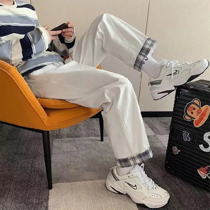 Chic High-Waist Cargo Denim showcased on a model sitting in an orange chair, paired with sporty sneakers.