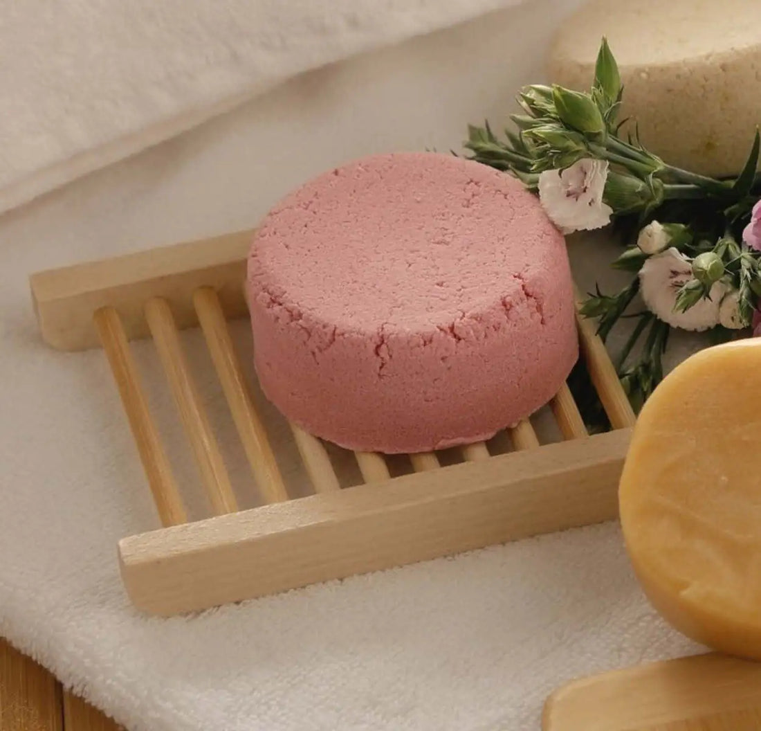 Eco Bath 6-Piece Kit featuring a round pink bath tablet on a wooden soap dish with floral accents.